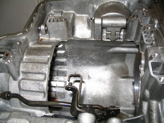 Interior view of an automatic transmission case showing gears and linkage