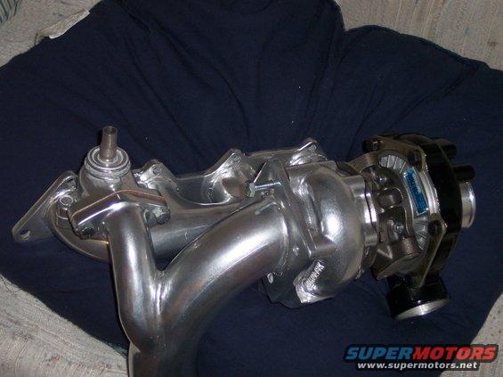 Polished turbocharger and exhaust manifold assembly, possibly for a Mitsubishi Mirage