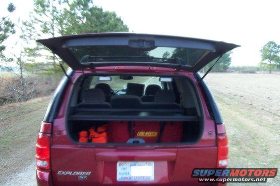 Red 2005 Ford Explorer rear view with open tailgate and "FIRE RESCUE" bags inside