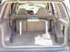 1985 Ford Bronco II - The rear interior of an SUV is shown, a custom roll cage with a prominent King shock absorber.