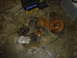 1986 Ford Mustang - Disassembled car brake components and a lug wrench lie on a dirty concrete floor next to a toolbox.