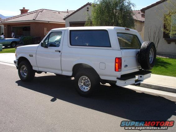 White 1996 Ford Bronco parked on a residential street, rear quarter view