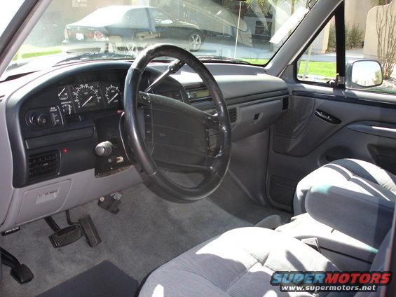 Gray fabric seats and dashboard of a truck, viewed from the passenger side