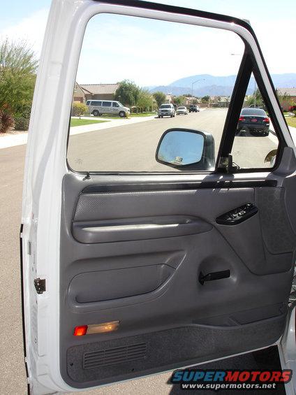 White truck interior with view of suburban street and other vehicles