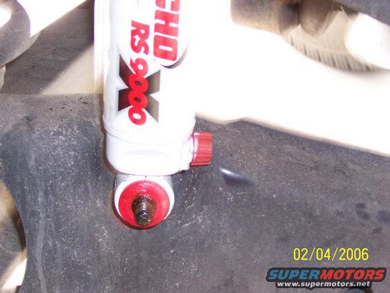 000_0055z.jpg Put on the ring and bushing. Install the top of the Rancho shock in first then install the bottom.