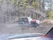 1995 Dodge 1500 - A red and white Jeep Wrangler Laredo navigates through a muddy, watery terrain surrounded by trees.