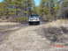 1995 Dodge 1500 - Jeep Cherokee XJ navigates a muddy, watery trail surrounded by trees.