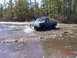 1995 Dodge 1500 - This truck is navigating a muddy, watery terrain, kicking up spray as it goes.