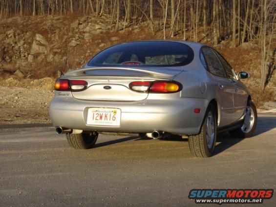 Silver 1999 Ford Taurus rear view with spoiler and license plate 12W K16
