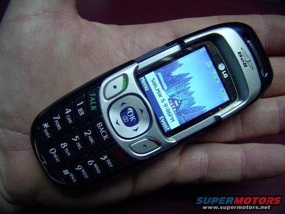 LG flip phone with "Bell" logo held in a hand. Screen shows date and time