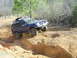 1996 Ford Bronco - This SUV is navigating a challenging off-road course with steep inclines and rough terrain.