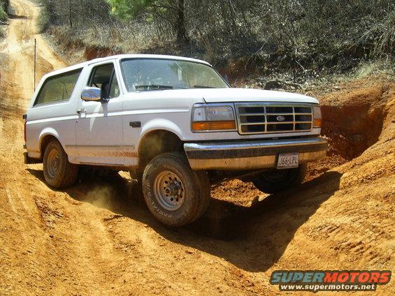 White 1996 Ford Bronco navigating a dirt trail