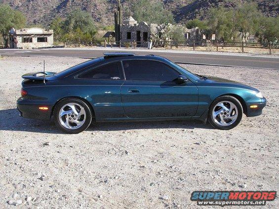 1993 Mazda MX-6 coupe, teal paint, aftermarket wheels, parked outdoors