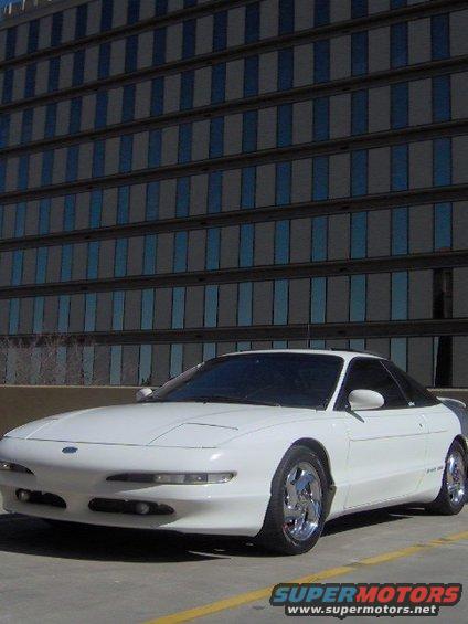 1996 Ford Probe coupe parked outside a building with reflective windows