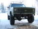 1990 Chevrolet Suburban - This 1990 Chevrolet Suburban is equipped with large off-road tires and a roof rack, seen here in a snowy environment.