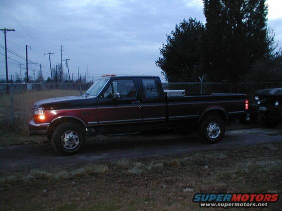 Two-tone Ford F-Series truck parked next to a Jeep