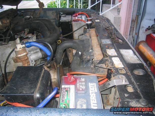 Engine bay with Interstate battery and blue hoses