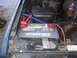 1986 Ford Bronco - Close-up of a vehicle's engine bay, focusing on the Interstate Mega-Tron battery and wiring.