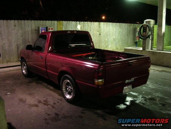 Red 1994 Ford Ranger pickup truck, rear 3/4 view