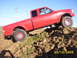 2000 Ford Ranger - A red pickup truck is shown climbing a dirt mound under a clear blue sky. The date 25/10/2005 is visible in the lower right corner.