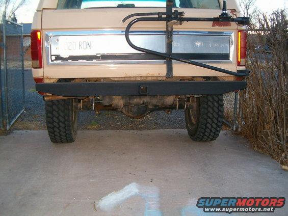Rear of a tan truck with a bike rack mounted on the tailgate. License plate reads 020 RDN