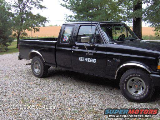 Black 1995 Ford F-150 pickup truck, driver's side view, with "AUGENT FOR GOVERNOR" text