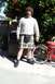 1990 Ford Bronco - A man wearing a kilt and a cream-colored sweater stands in front of a tree with oranges.