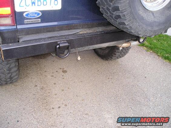 Rear bumper with tow hook and spare tire on a blue SUV