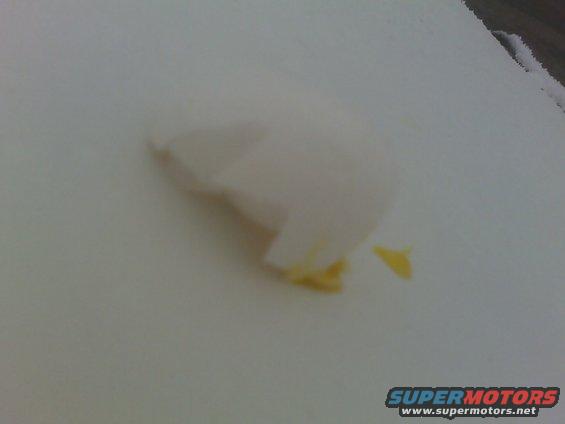White car part with yellow accents, possibly a bumper or fender piece