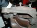 1979 Ford Bronco - This image shows a close-up view of a vehicle's brake caliper and rotor assembly, with visible bolts and rusty components.