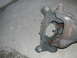 1979 Ford Bronco - A close-up view of an automotive suspension component, likely a spindle or knuckle, resting on a concrete surface. The SuperMotors logo is…