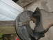 1979 Ford Bronco - A close-up view of a vehicle's brake rotor and part of its suspension system.