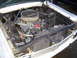 1964 Ford Fairlane - The engine bay of a 1964 Ford Fairlane shows its V8 engine, air filter, and radiator.