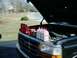 1992 Ford Bronco - Bottles of oil and other automotive fluids are lined up on the hood of a Ford truck with the engine exposed.