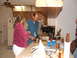 1966 Ford Ranchero - A couple prepares food in a kitchen, with a refrigerator and cabinets visible.