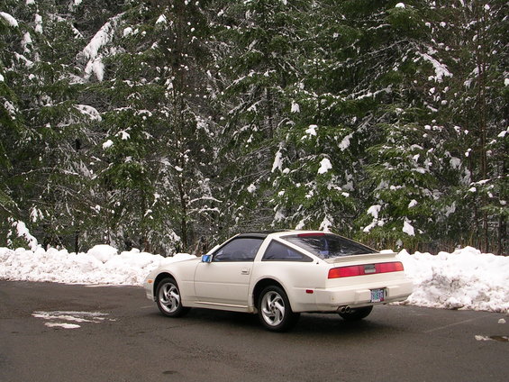 1989 Nissan 300ZX parked on asphalt with snow-covered trees in background