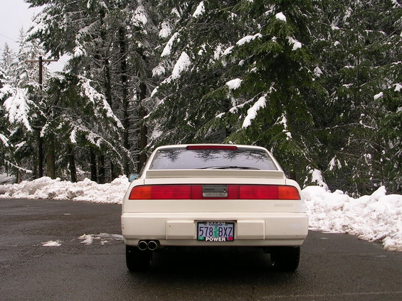 White 1989 Nissan 300ZX coupe rear view in snowy forest