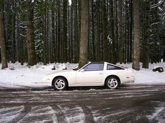 White 1989 Nissan 300ZX side view in snowy forest