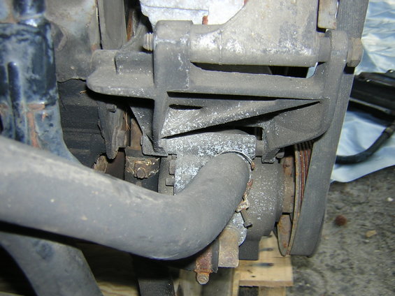 close-up of engine component with hoses and belt