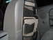 2004 Dodge 2500 - An interior organizer with numerous pockets is attached to the seat back of a vehicle.