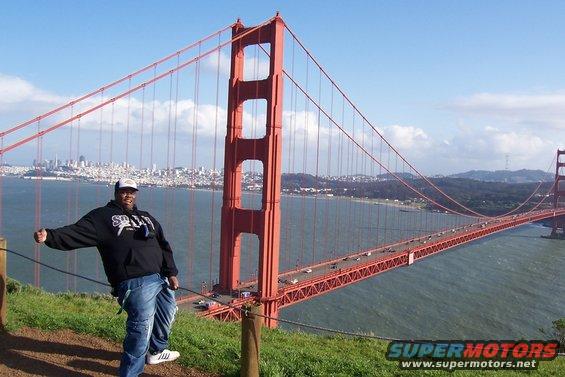 Person standing on a hill overlooking the Golden Gate Bridge and San Francisco skyline