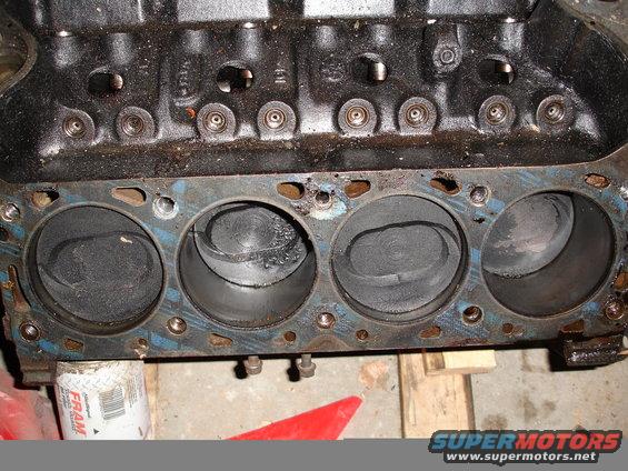 Engine block showing four cylinders with pistons. A FRAM oil filter is visible below