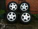 2001 Ford Fiesta - Set of four tires and wheels, likely for a Vauxhall vehicle, displayed outdoors.