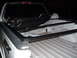 2003 Ford F-150 - The rear of a white Ford F-150 pickup truck, equipped with a black tonneau cover and an FX4 decal.