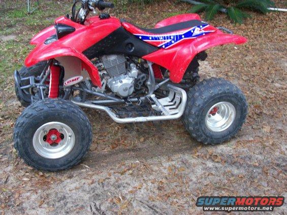 Red ATV with Confederate flag decal on the seat. It has a silver frame and black accents