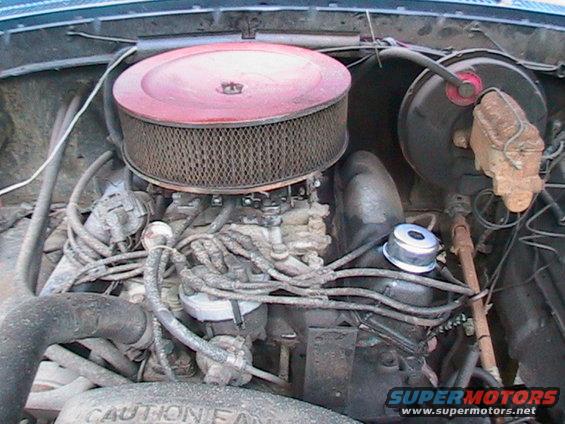 Engine bay showing carburetor, air cleaner, distributor, and brake booster