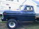 1977 Ford F-250 - A dark blue 1977 Ford F-250 pickup truck is parked outdoors next to a trailer.