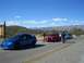1996 Ford Probe - Several Dodge Neon SRT-4s are lined up on a road with mountains in the background.