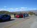1996 Ford Probe - Several Dodge Neon SRT-4s are parked along a road with mountains in the background.