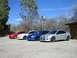 1996 Ford Probe - A lineup of four Dodge SRT-4 sedans in various colors under a bright blue sky.
